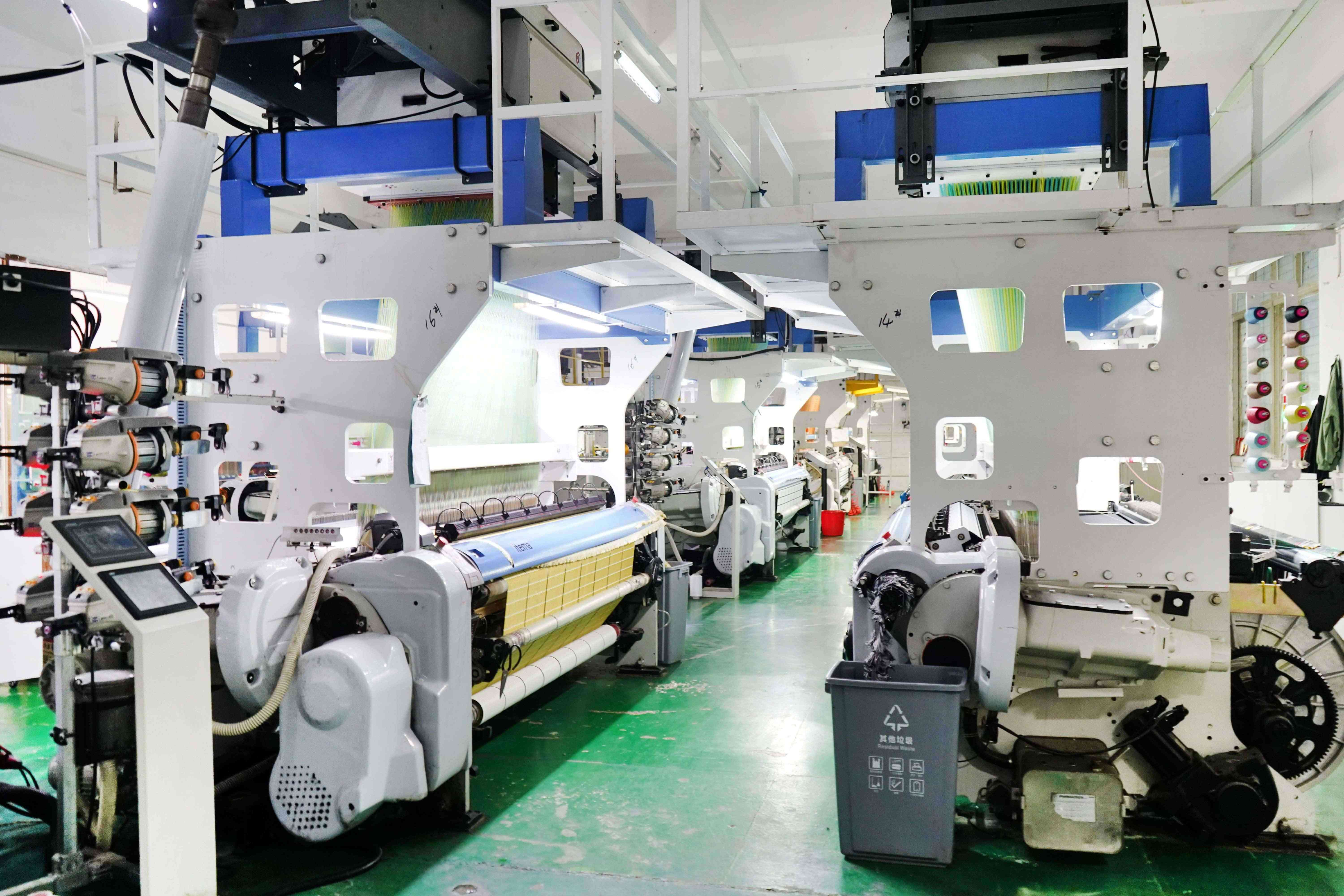 Factory production area showing GRS certified recycled label manufacturing and quality control process